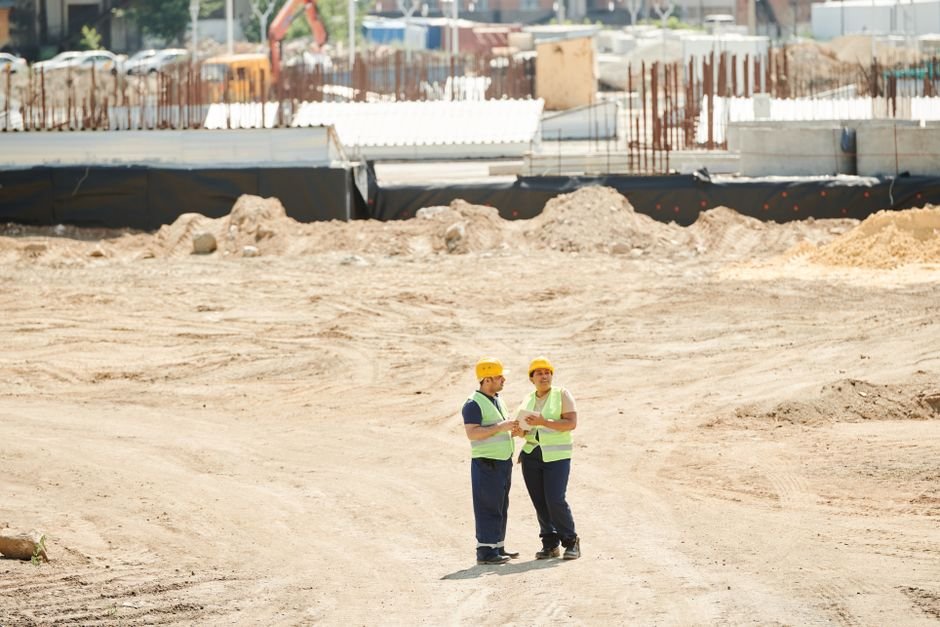 A civil engineer reviewing plans at a construction site