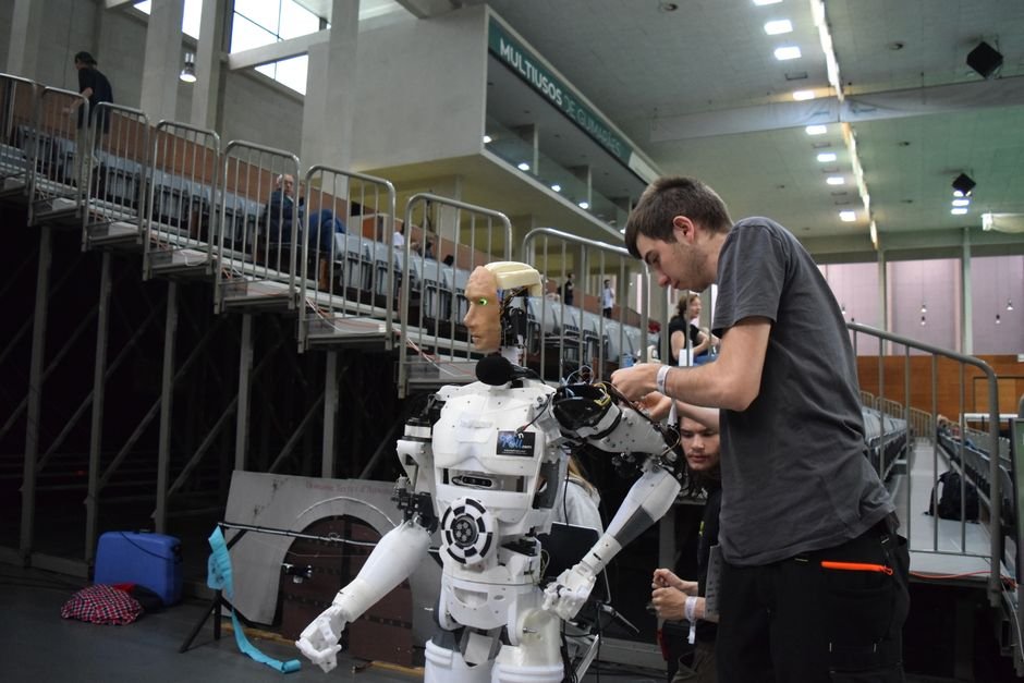 Technician working on a humanoid robot representing top universities in USA for robotics engineering
